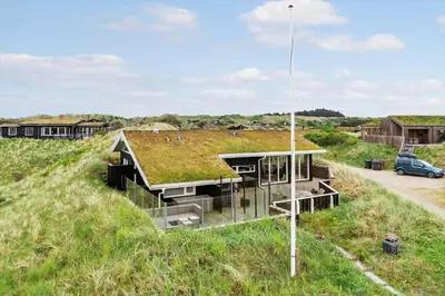 a house with a grass roof on top of a hill at BL161-Saltum-Taarnfalkevej-16 in Saltum