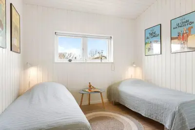 a bedroom with two beds and a window at BL1403-Blokhus-Sorensensvej-7 in Blokhus