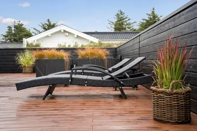 a pair of chairs sitting on a patio at BL1403-Blokhus-Sorensensvej-7 in Blokhus