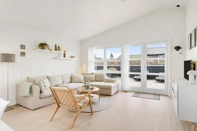 a white living room with a couch and a table at BL1403-Blokhus-Sorensensvej-7 in Blokhus