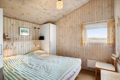 a bedroom with a bed and a window at BL1394-Pandrup-Tunen-2 in Pandrup