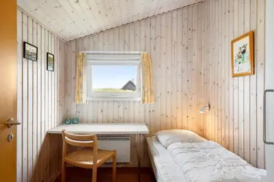 a small bedroom with a bed and a window at BL1394-Pandrup-Tunen-2 in Pandrup