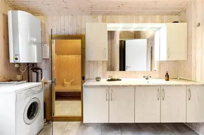 a kitchen with a sink and a washing machine at BL1259-Blokhus-Bag-Hojen-83 in Blokhus