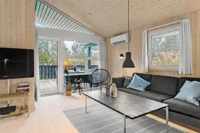 a living room with a couch and a table at BL1259-Blokhus-Bag-Hojen-83 in Blokhus