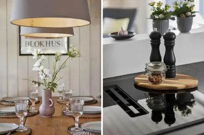 a kitchen with a table with plates and glasses at BL256-Blokhus-Skytten-35 in Blokhus