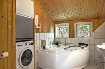 a bathroom with a washing machine and a sink at BL433-Blokhus-Raappenmark-8 in Blokhus