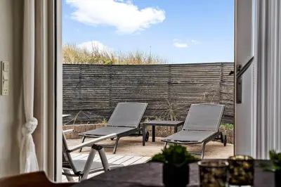 two chairs and a table on a patio at BL168-Saltum-Taarnfalkevej-11 in Saltum