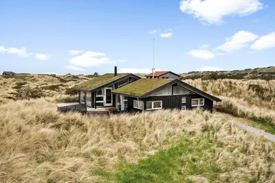 a house with a grass roof in a field at BL168-Saltum-Taarnfalkevej-11 in Saltum