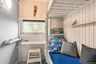 a tiny house with a bed and a sink at BL173-Blokhus-Bloksbjerg-88 in Blokhus