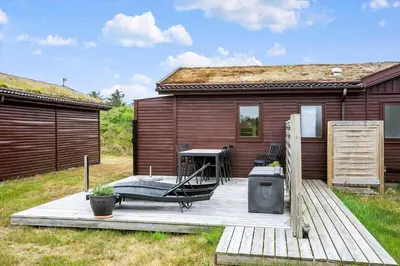 a wooden deck with a table and a house at BL1568-Saltum-P-Ejerstedgaardsvej-1-A in Saltum