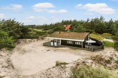 a house sitting on top of a beach at BL1202-Saltum-Revlingevej-6 in Saltum