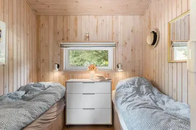 a small bedroom with two beds and a window at BL1202-Saltum-Revlingevej-6 in Saltum
