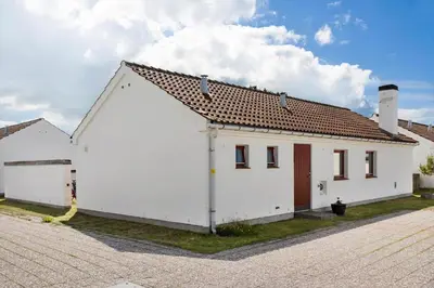 a white building with a brown roof at BL1397-Pandrup-Rodhus-Klitvej-363 in Pandrup