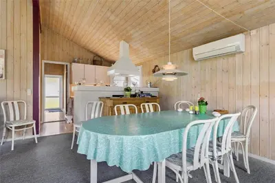 a kitchen and dining room with a table and chairs at BL1624-Blokhus-Jaegerbakken-1 in Blokhus