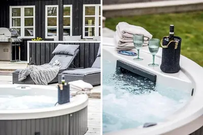 a bath tub with a bottle of wine and wine glasses at BL1280-Blokhus-Bloksbjerg-50 in Blokhus
