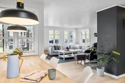 a living room with a couch and a table at BL1280-Blokhus-Bloksbjerg-50 in Blokhus