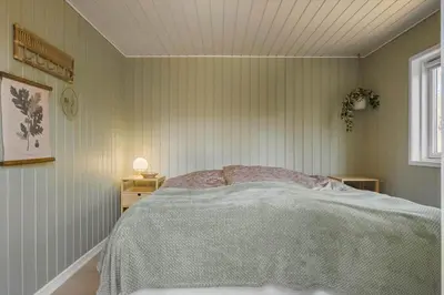 a bedroom with a bed and a window at BL1458-Blokhus-Lyngmarken-6 in Blokhus
