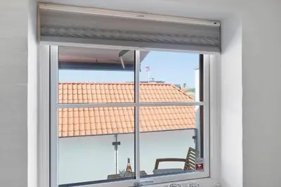a window with a view of a roof at BL1287-Blokhus-Klitgaardsvej-3-A-1-2 in Blokhus
