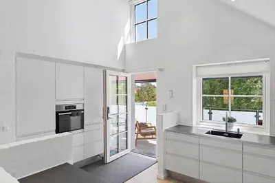 a white kitchen with a sink and a window at BL1287-Blokhus-Klitgaardsvej-3-A-1-2 in Blokhus