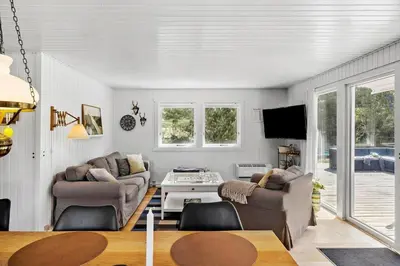 a living room with two couches and a table at BL1101-Pandrup-Rodhusparken-56 in Pandrup