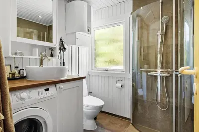 a bathroom with a toilet and a sink and a shower at BL1101-Pandrup-Rodhusparken-56 in Pandrup