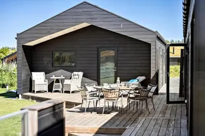 a patio with a table and chairs on a deck at BL1288-Saltum-Tolhoj-48 in Saltum