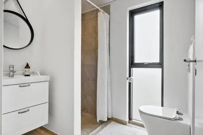 a bathroom with a toilet and a sink and a mirror at BL1288-Saltum-Tolhoj-48 in Saltum
