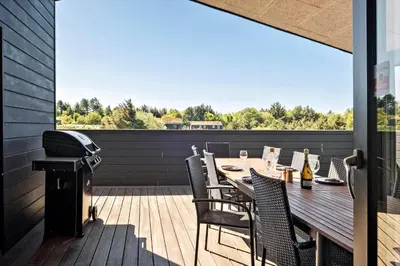 a deck with a table and chairs and a grill at BL1288-Saltum-Tolhoj-48 in Saltum