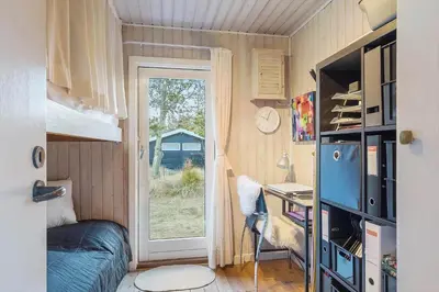 a bedroom with a bed and a desk with a window at BL1523-Saltum-Skanderborgvej-14 in Saltum