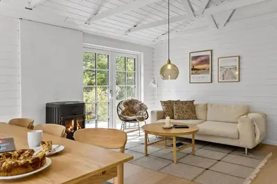 a living room with a couch and a table at BL1109-Blokhus-Bag-Hojen-78 in Blokhus