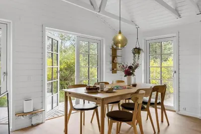 a dining room with a wooden table and chairs at BL1109-Blokhus-Bag-Hojen-78 in Blokhus