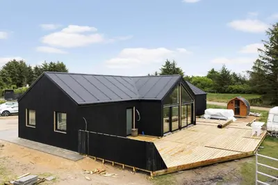 a black tiny house on a wooden deck at BL1108-Saltum-Vesterhavs-Sletten-45 in Saltum