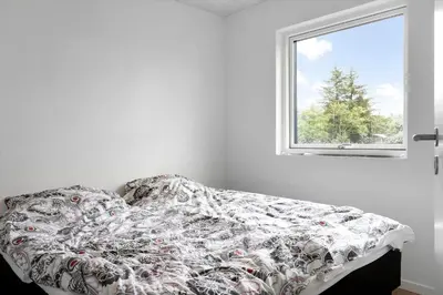 a bed in a white room with a window at BL1108-Saltum-Vesterhavs-Sletten-45 in Saltum