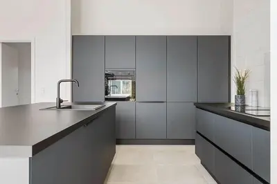 a kitchen with black and white cabinets and a sink at BL1295-Saltum-Vesterhavs-Sletten-39 in Saltum
