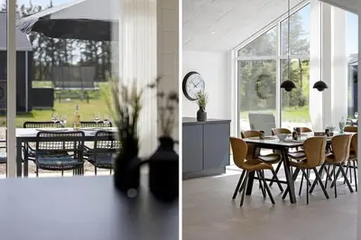 a dining room with a table and chairs and a clock at BL1295-Saltum-Vesterhavs-Sletten-39 in Saltum