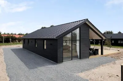 a black house with a lot of windows at BL1295-Saltum-Vesterhavs-Sletten-39 in Saltum
