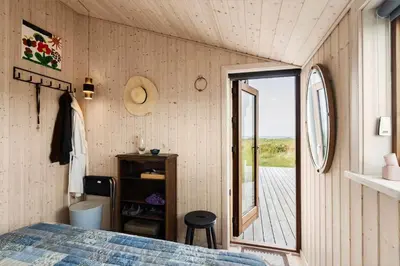 a bedroom in a tiny house with a window at BL1104-Saltum-Borgvej-45 in Saltum