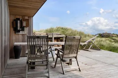 a wooden deck with a table and chairs on it at BL1104-Saltum-Borgvej-45 in Saltum