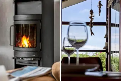 a glass of wine in front of a fireplace at BL1102-Blokhus-Solbakkevej-17 in Blokhus