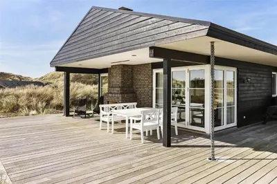 a pavilion with a table and chairs on a deck at BL1310-Blokhus-Moreavej-33-A in Blokhus