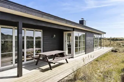 a house with a picnic table on a deck at BL1310-Blokhus-Moreavej-33-A in Blokhus