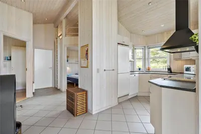 a kitchen with white appliances and a wooden ceiling at BL271-Blokhus-Taarnfalkevej-15 in Blokhus