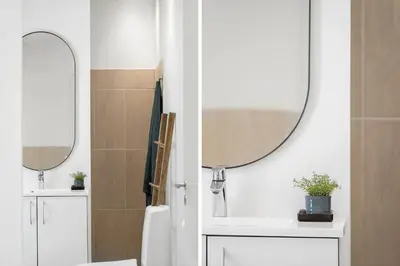 a bathroom with a sink and a mirror at BL1765-Blokhus-Plantagevej-2B in Blokhus