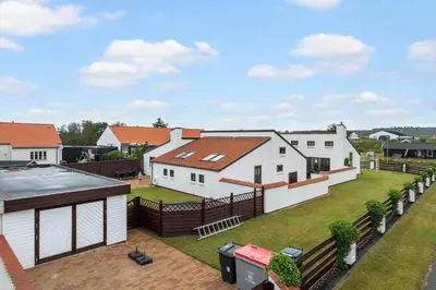 an aerial view of a white house with a yard at BL1117-Blokhus-Peter-Andersensvej-10 in Blokhus
