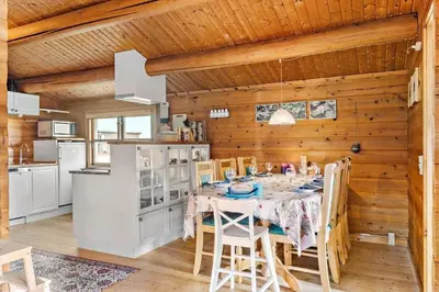 a kitchen and dining room with a table and chairs at G151-Lemvig-Porsevej-51 in Lemvig
