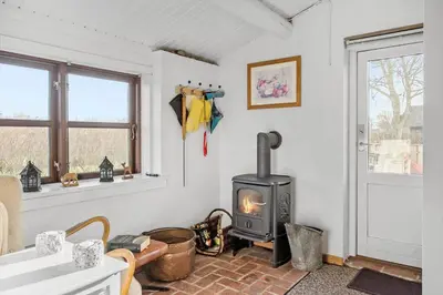 a living room with a stove in the corner at G151-Lemvig-Porsevej-51 in Lemvig