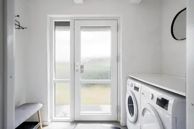 a white laundry room with a washing machine at 258-Harboore-Merchantvej-5 in Harboør