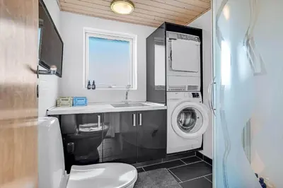 a bathroom with a washing machine and a sink at G430-Lemvig-Myntevej-30 in Lemvig