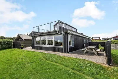 a black house with large windows on a lawn at G430-Lemvig-Myntevej-30 in Lemvig