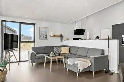 a living room with a couch and a table at 336-Harboore-Hvilehjemsvej-23 in Harboør